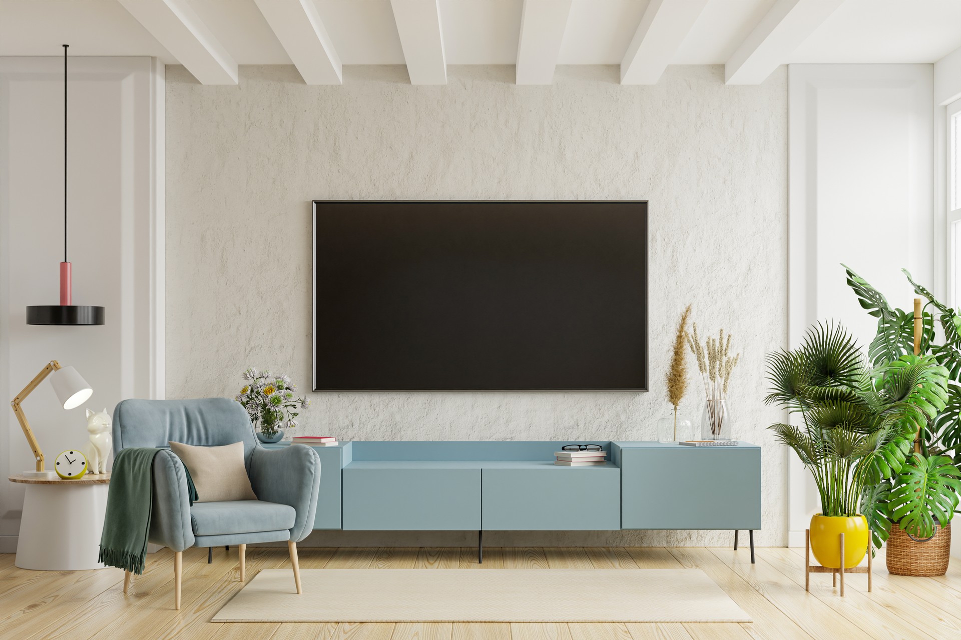 TV on the cabinet in modern living room with armchair on plaster wall background.